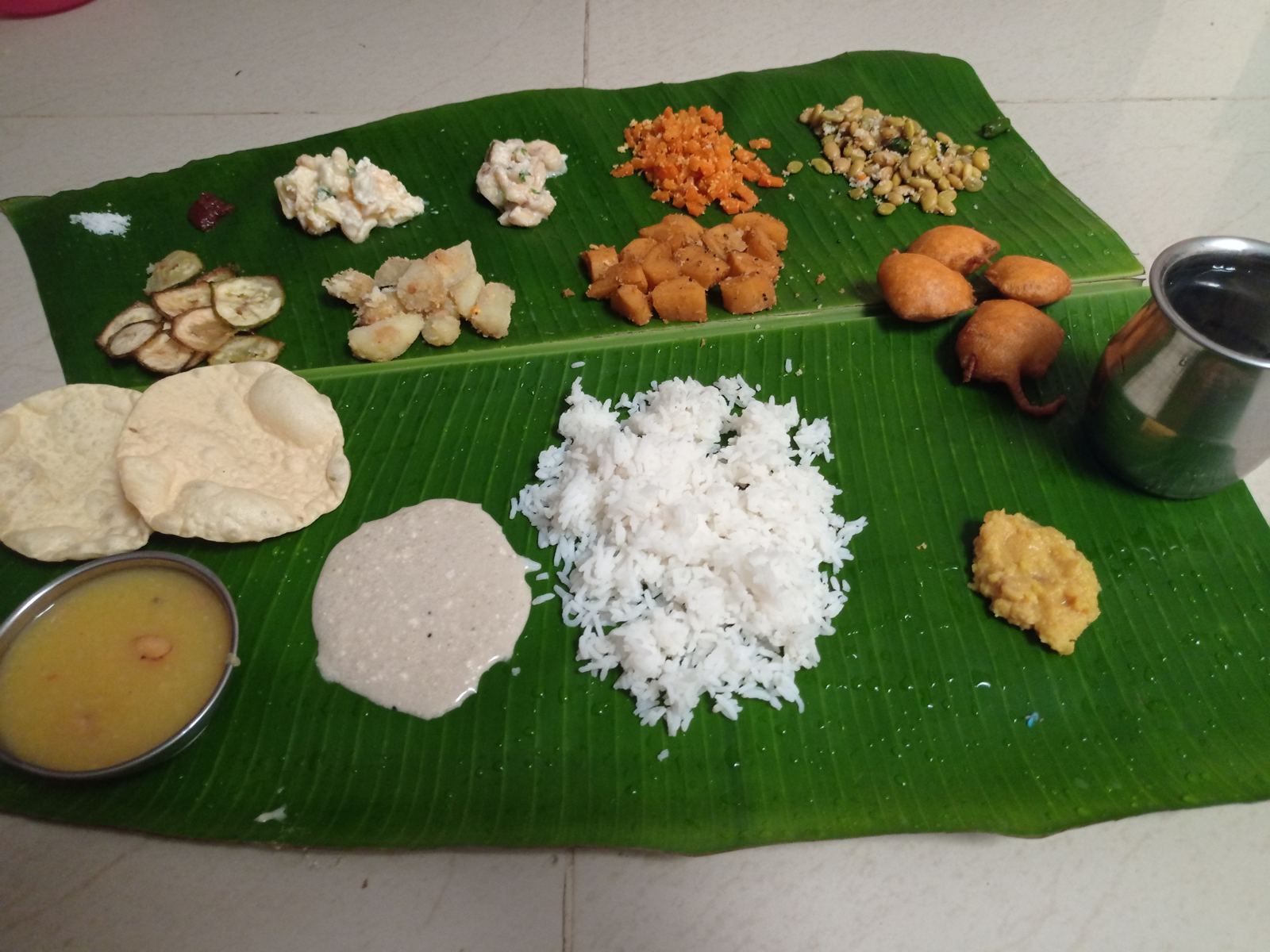 A festival meal laid out on banana leaves